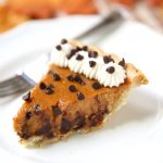 a piece of chocolate chip pumpkin pie on a white plate