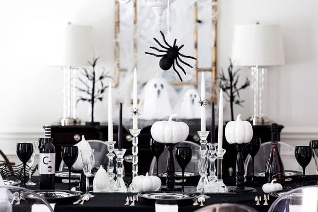 Pick a color scheme like black and white to style a chic Halloween party tablescape. Add in touches of spiders, ghosts, and cob webs for the ultimate dinner party!