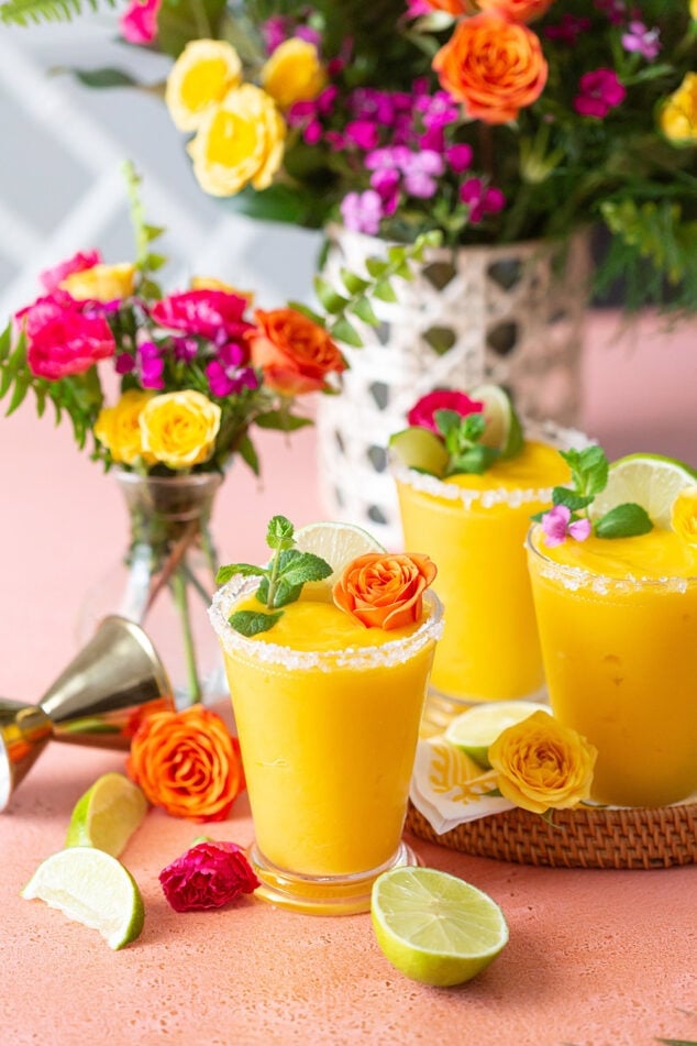 a tray of frozen mango margaritas with flowers