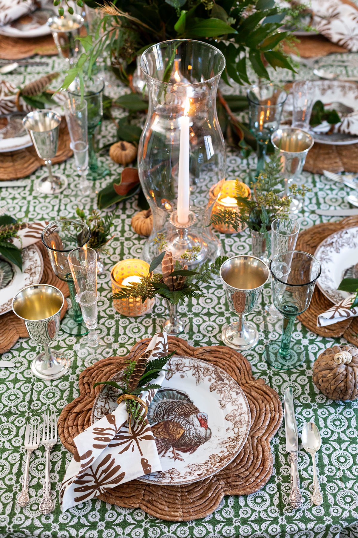 A Collected Green Thanksgiving Table with Rattan and Silver Touches